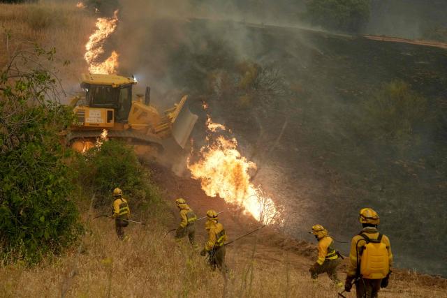 Firefighters battle a wildfire in Cebreros area, near Avila, 80 kms west of Madrid on July 24, 2026. Spain declared a national emergency in the Madrid region and in the province of Avila, near the capital, on July 23, 2026, in the wake of several wildfires burning out of control. Scientists have long warned that climatechange caused by human use of fossil fuels will make periods of drought more intense and longer-lasting, creating the ideal conditions for wildfires. (Photo by Cesar MANSO / AFP)