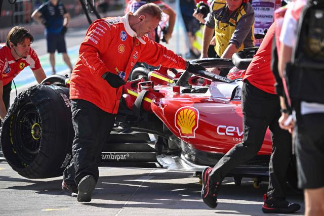 The car of Ferrari's Monegasque driver Charles Leclerc is pushed back to the pits by mechanics during the second practice of Formula One Hungarian Grand Prix at the Hungaroring circuit in Mogyorod near Budapest, Hungary, on July 24, 2026. (Photo by Attila KISBENEDEK / AFP)