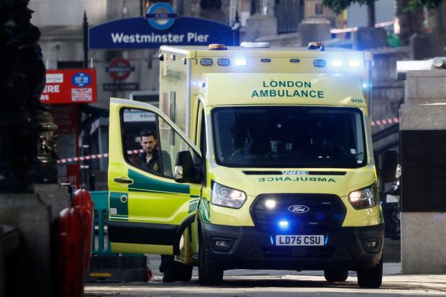 Members of the emergency services work near the scene of an incident involving a boat crashing into Westminster Bridge in central London on July 24, 2026, injuring a number of officers from the Met's Marine Policing Unit. Five London police officers were injured Friday after their boat patrolling the River Thames struck Westminster Bridge and they went into the water, the UK capital's Metropolitan Police Service said. (Photo by Brook Mitchell / AFP)