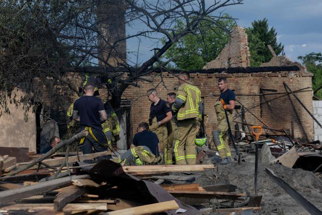 Rescuers work in the rubble of private houses at the site of a Russian missile strikes at an undisclosed location in Kyiv region on July 24, 2026, amid the Russian invasion of Ukraine. (Photo by Tetiana DZHAFAROVA / AFP)