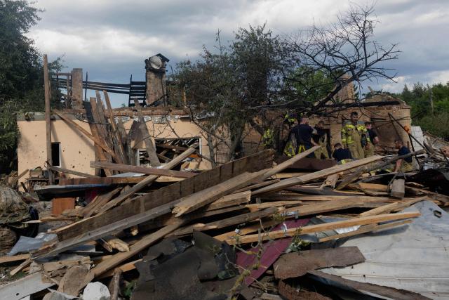 Rescuers work in the rubble of private houses at the site of a Russian missile strikes at an undisclosed location in Kyiv region on July 24, 2026, amid the Russian invasion of Ukraine. (Photo by Tetiana DZHAFAROVA / AFP)