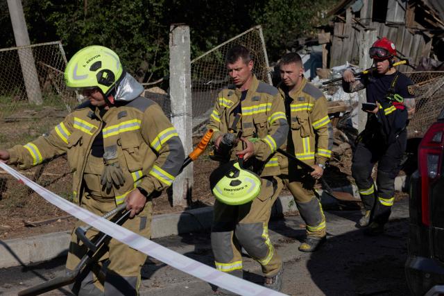 Firefighters work near the site of a Russian missile strike at an undisclosed location in Kyiv region on July 24, 2026, amid the Russian invasion of Ukraine. (Photo by Tetiana DZHAFAROVA / AFP)