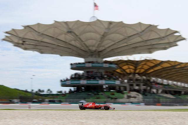 (FILES) Ferrari's German driver Sebastian Vettel drives his car during the third practice session of the Formula One Malaysia Grand Prix in Sepang on September 30, 2017. The Malaysian government is carrying out a feasibility study into hosting a Grand Prix later this year as the Middle East war continues to threaten the latter stages of the 2026 Formula One season. Youth and sports minister Mohammed Taufiq Johari said they were "actively conducting discussions and assessing the proposal" in a statement from the Malaysia government issued on July 24, 2026. (Photo by MANAN VATSYAYANA / AFP)