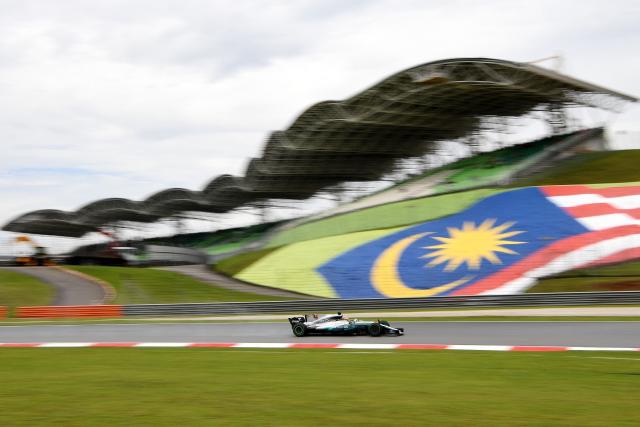 (FILES) Mercedes's British driver Lewis Hamilton powers his car during the first practice session of the Formula One Malaysia Grand Prix in Sepang on September 29, 2017. The Malaysian government is carrying out a feasibility study into hosting a Grand Prix later this year as the Middle East war continues to threaten the latter stages of the 2026 Formula One season. Youth and sports minister Mohammed Taufiq Johari said they were "actively conducting discussions and assessing the proposal" in a statement from the Malaysia government issued on July 24, 2026. (Photo by MANAN VATSYAYANA / AFP)