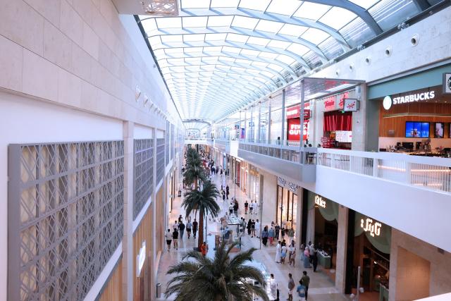 People wonder through one of Kuwait's biggest shopping malls, The Al-Khiran Mall, 80kms south of Kuwait City on July 24, 2026. (Photo by YASSER AL-ZAYYAT / AFP)