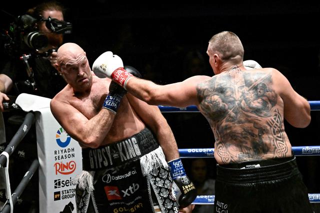 Britain's Tyson Fury (L) trades blows with Poland's Mariusz Wach (R) during a charity boxing bout in Pattaya on July 24, 2026. (Photo by Lillian SUWANRUMPHA / AFP)