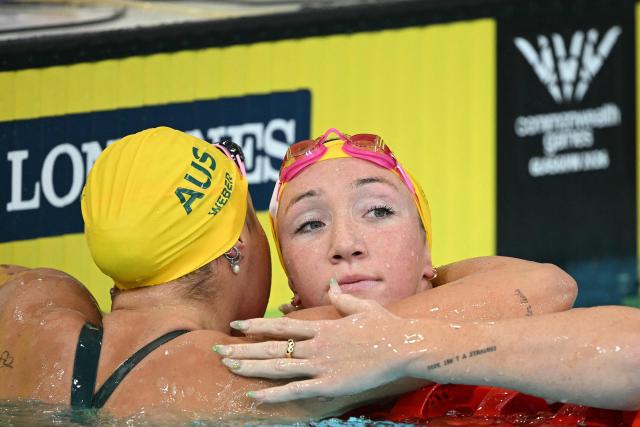 Australia's Lani Pallister (R) celebrates winning the women's 400m Freestyle final during the swimming event at the Tollcross International Swimming Centre in Glasgow, on day one of the Commonwealth Games in Glasgow, Scotland, on July 24, 2026. (Photo by Oli SCARFF / AFP)