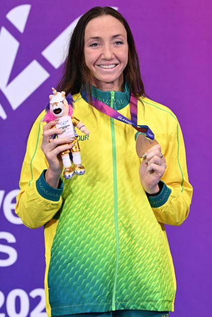 Bronze Australia's Jenna Forrester celebrates during the Women's 400m Freestyle Medal Ceremony at the swimming event at the Tollcross International Swimming Centre in Glasgow, on day one of the Commonwealth Games in Glasgow, Scotland, on July 24, 2026. (Photo by Oli SCARFF / AFP)
