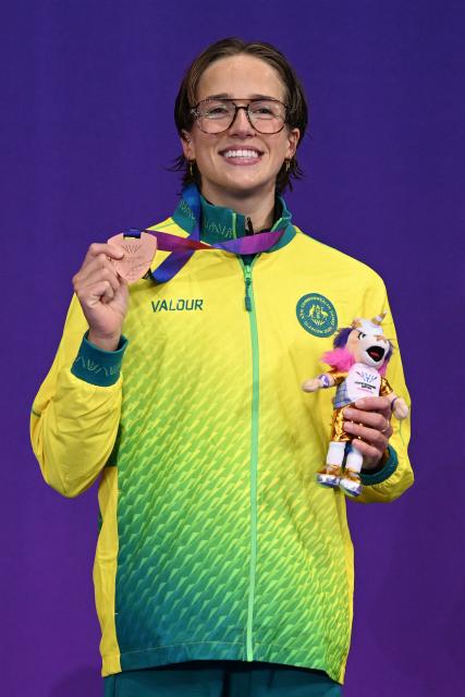 Bronze medallist Australia's Jenna Forrester celebrates during the Women's 400m Freestyle Medal Ceremony at the swimming event at the Tollcross International Swimming Centre in Glasgow, on day one of the Commonwealth Games in Glasgow, Scotland, on July 24, 2026. (Photo by Oli SCARFF / AFP)