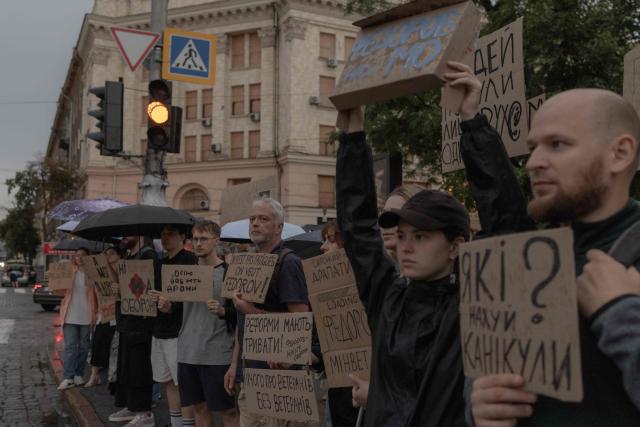 Protesters hold placards during the ninth day of a demonstration against Ukrainian President's decision to dismiss the country's former defence minister, in the eastern city of Kharkiv on July 24, 2026, amid the Russian invasion of Ukraine. Ukraine's ex-defence minister - whose ousting trigged a week of protests and forced out the country's commander-in-chief - said on July 23, 2026, he was rejecting offers by Ukraine's President for a new role. (Photo by Roman PILIPEY / AFP)