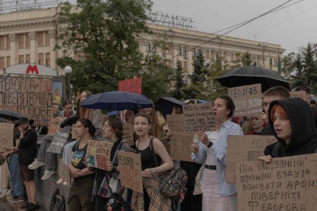 Protesters hold placards during the ninth day of a demonstration against Ukrainian President's decision to dismiss the country's former defence minister, in the eastern city of Kharkiv on July 24, 2026, amid the Russian invasion of Ukraine. Ukraine's ex-defence minister - whose ousting trigged a week of protests and forced out the country's commander-in-chief - said on July 23, 2026, he was rejecting offers by Ukraine's President for a new role. (Photo by Roman PILIPEY / AFP)