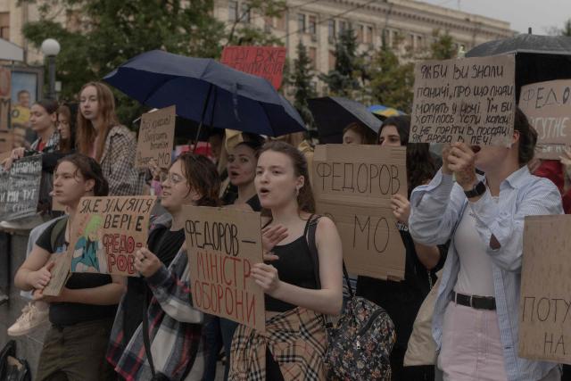 Protesters hold placards during the ninth day of a demonstration against Ukrainian President's decision to dismiss the country's former defence minister, in the eastern city of Kharkiv on July 24, 2026, amid the Russian invasion of Ukraine. Ukraine's ex-defence minister - whose ousting trigged a week of protests and forced out the country's commander-in-chief - said on July 23, 2026, he was rejecting offers by Ukraine's President for a new role. (Photo by Roman PILIPEY / AFP)