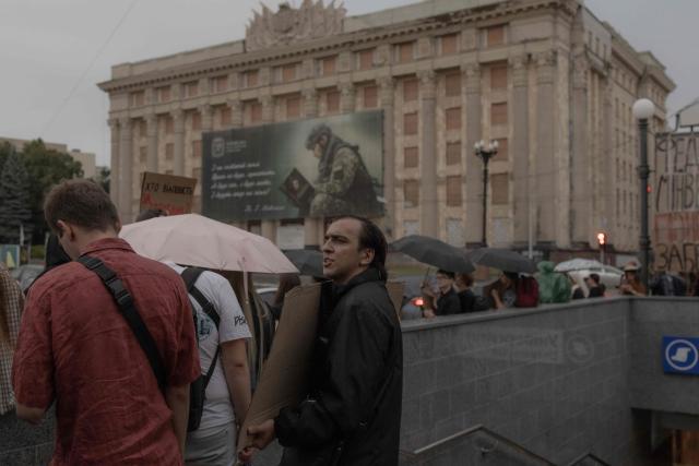 Protesters holding placards attend the ninth day of a demonstration against Ukrainian President's decision to dismiss the country's former defence minister, in the eastern city of Kharkiv on July 24, 2026, amid the Russian invasion of Ukraine. Ukraine's ex-defence minister - whose ousting trigged a week of protests and forced out the country's commander-in-chief - said on July 23, 2026, he was rejecting offers by Ukraine's President for a new role. (Photo by Roman PILIPEY / AFP)