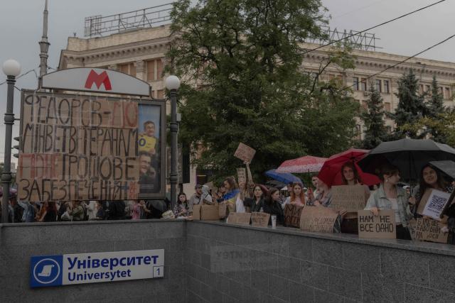 Protesters hold placards during the ninth day of a demonstration against Ukrainian President's decision to dismiss the country's former defence minister, in the eastern city of Kharkiv on July 24, 2026, amid the Russian invasion of Ukraine. Ukraine's ex-defence minister - whose ousting trigged a week of protests and forced out the country's commander-in-chief - said on July 23, 2026, he was rejecting offers by Ukraine's President for a new role. (Photo by Roman PILIPEY / AFP)