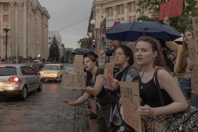 Protesters hold placards during the ninth day of a demonstration against Ukrainian President's decision to dismiss the country's former defence minister, in the eastern city of Kharkiv on July 24, 2026, amid the Russian invasion of Ukraine. Ukraine's ex-defence minister - whose ousting trigged a week of protests and forced out the country's commander-in-chief - said on July 23, 2026, he was rejecting offers by Ukraine's President for a new role. (Photo by Roman PILIPEY / AFP)