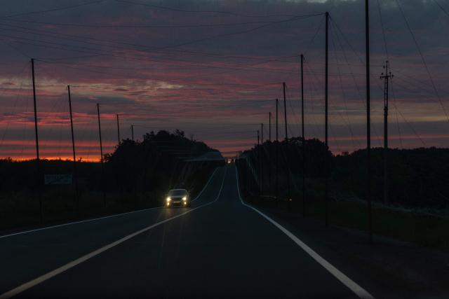 A car drives along a road covered with anti-drone nets in the eastern Kharkiv region on July 23, 2026, amid the Russian invasion of Ukraine. (Photo by Roman PILIPEY / AFP)