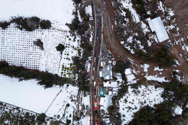 Aerial view of Juntas de Valeriano in Huasco province, Atacama region, Chile on July 23, 2026. Heavy rains in Chile have killed at least 13 people and left more than 60,000 others cut off due to washed out roads, government officials said in a report on June 21, as the recovery effort focused on restoring basic services. (Photo by Jose TORRES / AFP)