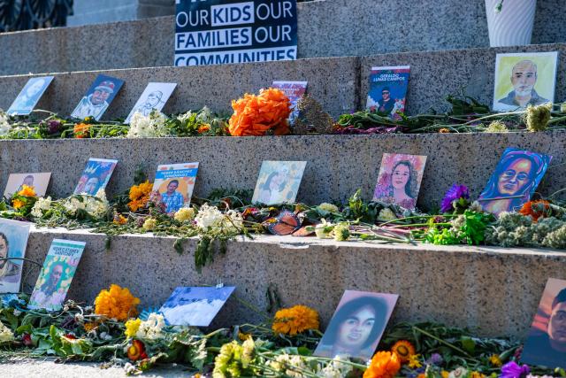 Pictures of people who have been killed during US Immigration and Customs Enforcement (ICE) operations lay on the steps of the State House during a 24-hour vigil in Boston, on July 24, 2026. (Photo by JOSEPH PREZIOSO / AFP)