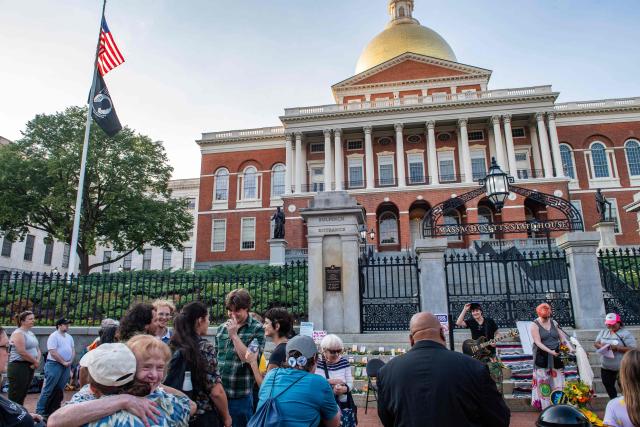 People view a memorial honoring people who have been killed during US Immigration and Customs Enforcement (ICE) operations on the steps of the State House during a 24-hour vigil in Boston, on July 24, 2026. (Photo by JOSEPH PREZIOSO / AFP)
