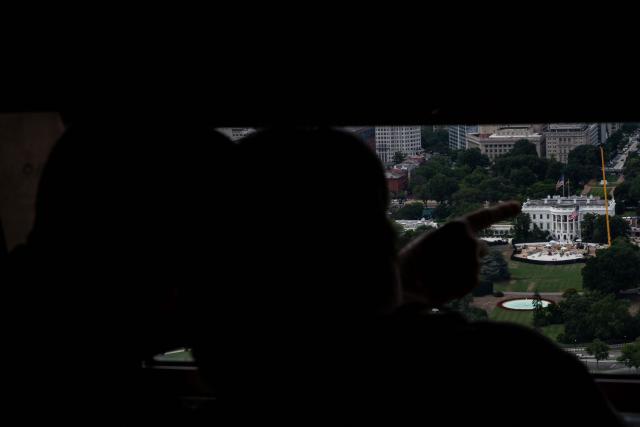 Visitors point from the observation deck of the Washington Monument in Washington, DC on July 24, 2026. (Photo by Kent Nishimura / AFP)