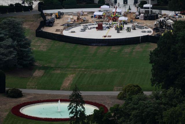 Lettering is placed on the site of where a black granite helipad is being constructed on the South lawn of the White House, as seen from the observation deck of the Washington Monument in Washington, DC on July 24, 2026. (Photo by Kent Nishimura / AFP)