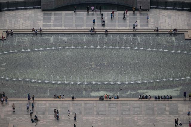 The fountain of the World War II Memorial is seen from the observation deck of the Washington Monument in Washington, DC on July 24, 2026. (Photo by Kent Nishimura / AFP)