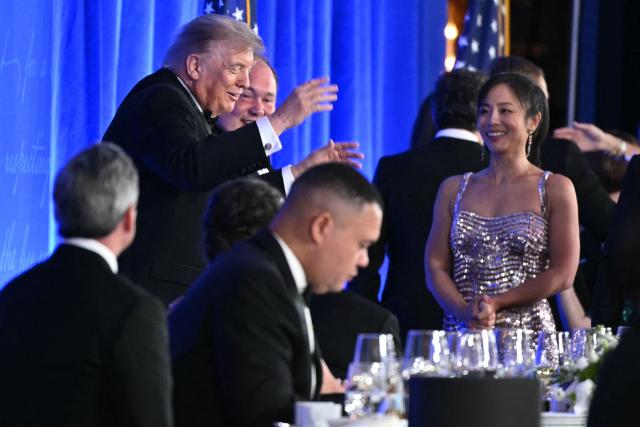US President Donald Trump throws his hands up in the air after shaking hands with Wall Street Journal journalist Josh Dawsey during the 2026 White House Correspondents' Association (WHCA) Dinner at the Waldorf Astoria in Washington, DC, on July 24, 2026. The 2026 WHCA Dinner was originally scheduled for April 25 at the Washington Hilton, but was rescheduled and relocated after an alleged gunman breached security. (Photo by Mandel NGAN / AFP)