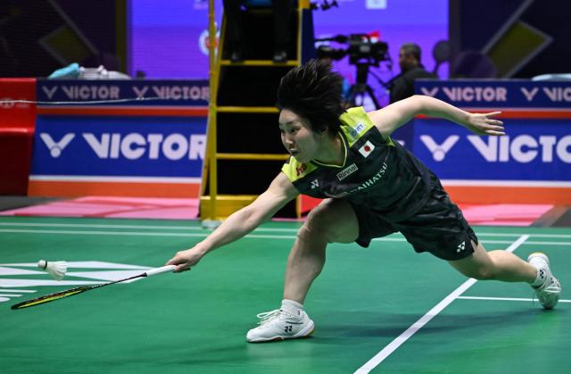 Japan's Akane Yamaguchi hits a return to China's Wang Zhiyi during their women's singles semifinal match at the China Open badminton tournament in Changzhou, eastern China's Jiangsu province on July 25, 2026. (Photo by CN-STR / AFP) / China OUT