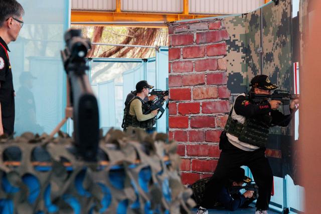 Members of the public take part in the northern regional preliminary round of the inaugural National Airsoft Shooting Competition, which organisers said was aimed at strengthening Taiwan’s whole-of-society defence resilience, at the National Defence University’s Fuxinggang campus in Taipei on July 25, 2026. (Photo by CHENG Yu-chen / AFP)