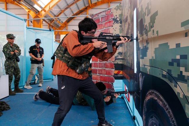 Members of the public take part in the northern regional preliminary round of the inaugural National Airsoft Shooting Competition, which organisers said was aimed at strengthening Taiwan’s whole-of-society defence resilience, at the National Defence University’s Fuxinggang campus in Taipei on July 25, 2026. (Photo by CHENG Yu-chen / AFP)