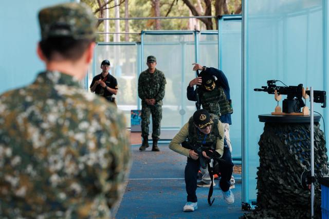 Members of the public take part in the northern regional preliminary round of the inaugural National Airsoft Shooting Competition, which organisers said was aimed at strengthening Taiwan’s whole-of-society defence resilience, at the National Defence University’s Fuxinggang campus in Taipei on July 25, 2026. (Photo by CHENG Yu-chen / AFP)