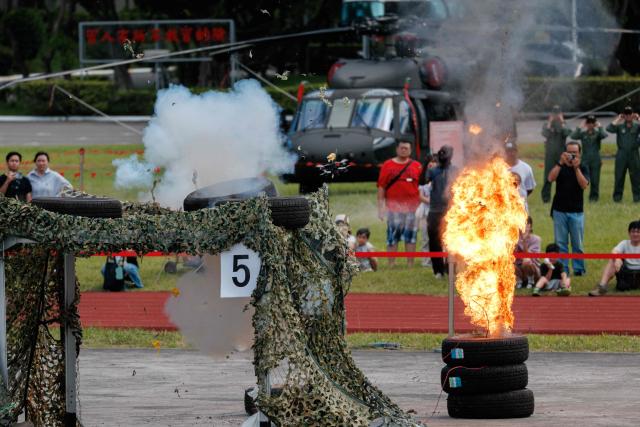 Members of the public watch as Taiwan’s Army Special Operations Command operates four JMG Viper 7 drones in a simulated coordinated strike on an enemy command post, in a demonstration aimed at highlighting asymmetric warfare capabilities, during an open day at the National Defence University’s Fuxinggang campus in Taipei on July 25, 2026. (Photo by CHENG Yu-chen / AFP)