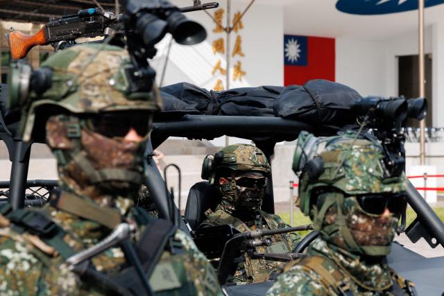 Taiwanese soldiers instruct visitors on the use of military equipment during an open day at the National Defence University’s Fuxinggang campus in Taipei on July 25, 2026. (Photo by CHENG Yu-chen / AFP)