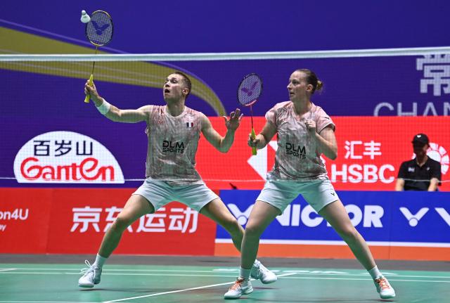 France's Thom Gicquel and Delphine Delrue play against China's Feng Yan Zhe and Huang Dongping during their mixed doubles semifinal match at the China Open badminton tournament in Changzhou, eastern China's Jiangsu province on July 25, 2026. (Photo by CN-STR / AFP) / China OUT