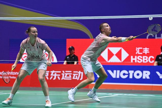 France's Thom Gicquel and Delphine Delrue play against China's Feng Yan Zhe and Huang Dongping during their mixed doubles semifinal match at the China Open badminton tournament in Changzhou, eastern China's Jiangsu province on July 25, 2026. (Photo by CN-STR / AFP) / China OUT
