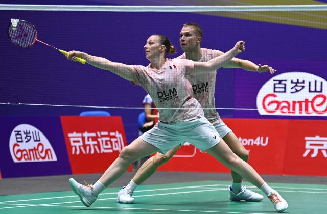 France's Thom Gicquel and Delphine Delrue play against China's Feng Yan Zhe and Huang Dongping during their mixed doubles semifinal match at the China Open badminton tournament in Changzhou, eastern China's Jiangsu province on July 25, 2026. (Photo by CN-STR / AFP) / China OUT