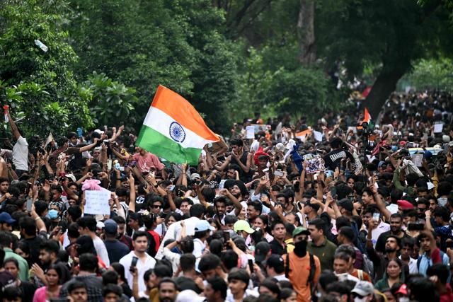 Cockroach Janta Party (CJP) supporters celebrate the resignation of India's Education Minister Dharmendra Pradhan, at Jantar Mantar in New Delhi on July 25, 2026 amid the ongoing protests over alleged NEET exam irregularities. India's education minister Dharmendra Pradhan on July 25 sent his resignation to Prime Minister Narendra Modi after the youth-led Cockroach Janta Party online movement weeks-long protest over irregularities in the education department. (Photo by Sajjad HUSSAIN / AFP)