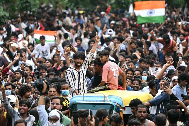 Cockroach Janta Party (CJP) supporters celebrate the resignation of India's Education Minister Dharmendra Pradhan, at Jantar Mantar in New Delhi on July 25, 2026 amid the ongoing protests over alleged NEET exam irregularities. India's education minister Dharmendra Pradhan on July 25 sent his resignation to Prime Minister Narendra Modi after the youth-led Cockroach Janta Party online movement weeks-long protest over irregularities in the education department. (Photo by Sajjad HUSSAIN / AFP)