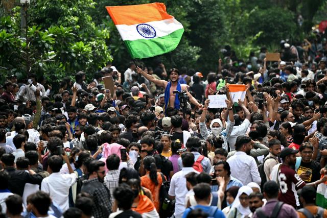 Cockroach Janta Party (CJP) supporters celebrate the resignation of India's Education Minister Dharmendra Pradhan, at Jantar Mantar in New Delhi on July 25, 2026 amid the ongoing protests over alleged NEET exam irregularities. India's education minister Dharmendra Pradhan on July 25 sent his resignation to Prime Minister Narendra Modi after the youth-led Cockroach Janta Party online movement weeks-long protest over irregularities in the education department. (Photo by Sajjad HUSSAIN / AFP)