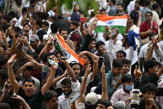 Cockroach Janta Party (CJP) supporters celebrate the resignation of India's Education Minister Dharmendra Pradhan, at Jantar Mantar in New Delhi on July 25, 2026 amid the ongoing protests over alleged NEET exam irregularities. India's education minister Dharmendra Pradhan on July 25 sent his resignation to Prime Minister Narendra Modi after the youth-led Cockroach Janta Party online movement weeks-long protest over irregularities in the education department. (Photo by Sajjad HUSSAIN / AFP)