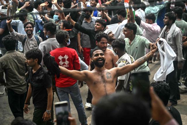 Cockroach Janta Party (CJP) supporters celebrate the resignation of India's Education Minister Dharmendra Pradhan, at Jantar Mantar in New Delhi on July 25, 2026 amid the ongoing protests over alleged NEET exam irregularities. India's education minister Dharmendra Pradhan resigned on July 25, after mass youth-led protests demanded his ouster in anger over a string of irregularities in potentially life-changing exams. (Photo by Arun SANKAR / AFP)