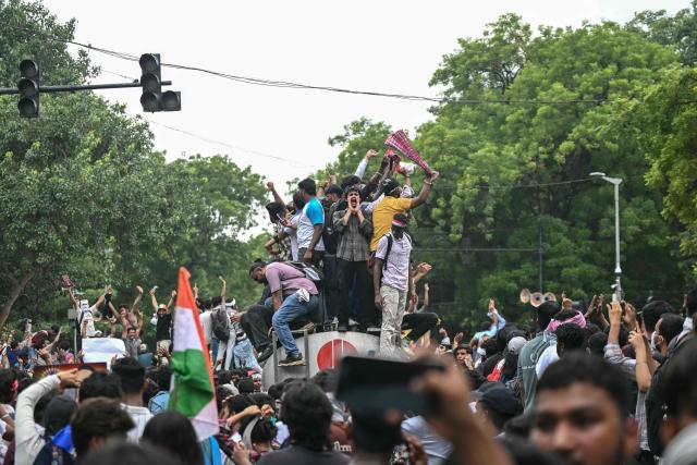 Cockroach Janta Party (CJP) supporters celebrate the resignation of India's Education Minister Dharmendra Pradhan, at Jantar Mantar in New Delhi on July 25, 2026 amid the ongoing protests over alleged NEET exam irregularities. India's education minister Dharmendra Pradhan resigned on July 25, after mass youth-led protests demanded his ouster in anger over a string of irregularities in potentially life-changing exams. (Photo by Arun SANKAR / AFP)