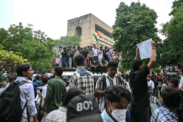 Cockroach Janta Party (CJP) supporters celebrate the resignation of India's Education Minister Dharmendra Pradhan, at Jantar Mantar in New Delhi on July 25, 2026 amid the ongoing protests over alleged NEET exam irregularities. India's education minister Dharmendra Pradhan resigned on July 25, after mass youth-led protests demanded his ouster in anger over a string of irregularities in potentially life-changing exams. (Photo by Arun SANKAR / AFP)