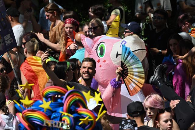 Participants attend the Christopher Street Day (CSD) parade in Berlin on July 25, 2026. This year's CSD parade takes place under the slogan 'Taking a stand is Hot', where various groups will demonstrate in support of diversity, human rights, and the protection of minorities. (Photo by RALF HIRSCHBERGER / AFP)