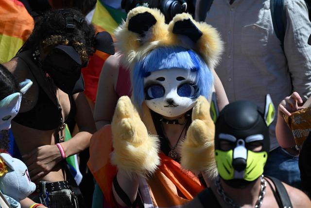 Participants in costumes attend the Christopher Street Day (CSD) parade in Berlin on July 25, 2026. This year's CSD parade takes place under the slogan 'Taking a stand is Hot', where various groups will demonstrate in support of diversity, human rights, and the protection of minorities. (Photo by RALF HIRSCHBERGER / AFP)