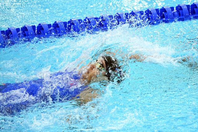 Australia's Hannah Fredericks competes in the Women's 100m Backstroke heats during the swimming event at the Tollcross International Swimming Centre in Glasgow, on day two of the Commonwealth Games in Glasgow, Scotland, on July 25, 2026. (Photo by Oli SCARFF / AFP)