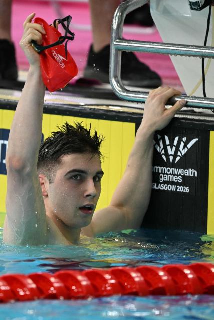 England's William Ellard reacts after breaking the games record in the Men's 200m S14 Freestyle heats during the swimming event at the Tollcross International Swimming Centre in Glasgow, on day two of the Commonwealth Games in Glasgow, Scotland, on July 25, 2026. (Photo by Oli SCARFF / AFP)