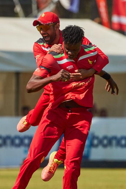 Zimbabwe captain Sikandar Raza (L) celebrates the wicket of Vaibhav Sooryavanshi (unseen) with Blessing Muzarabani during of the second Twenty20 international cricket match between Zimbabwe and India at Harare Sports Club in Harare, on July 25, 2026. (Photo by Jekesai NJIKIZANA / AFP)