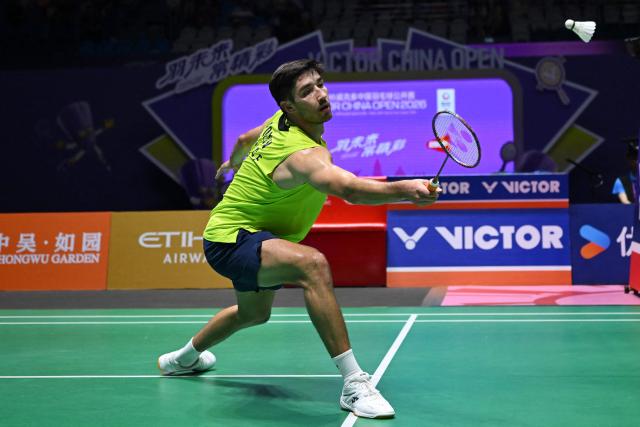 France's Toma Junior Popov hits a return to Canada's Victor Lai during men's singles semi-final match at the China Open badminton open in Changzhou, eastern China's Jiangsu province on July 25, 2026. (Photo by CN-STR / AFP) / China OUT