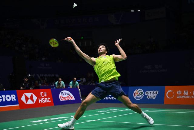 France's Toma Junior Popov hits a return to Canada's Victor Lai during men's singles semi-final match at the China Open badminton open in Changzhou, eastern China's Jiangsu province on July 25, 2026. (Photo by CN-STR / AFP) / China OUT